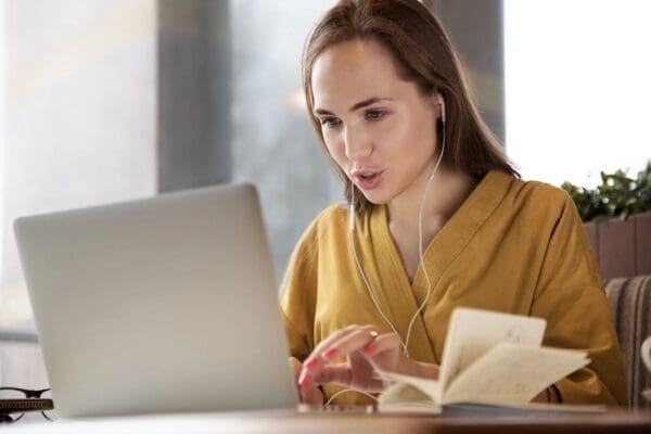 Woman using a laptop with earphones.
